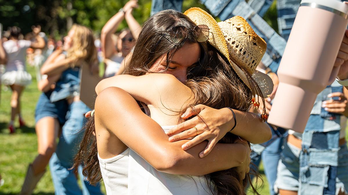 Two students hug on the Administration Building Lawn.